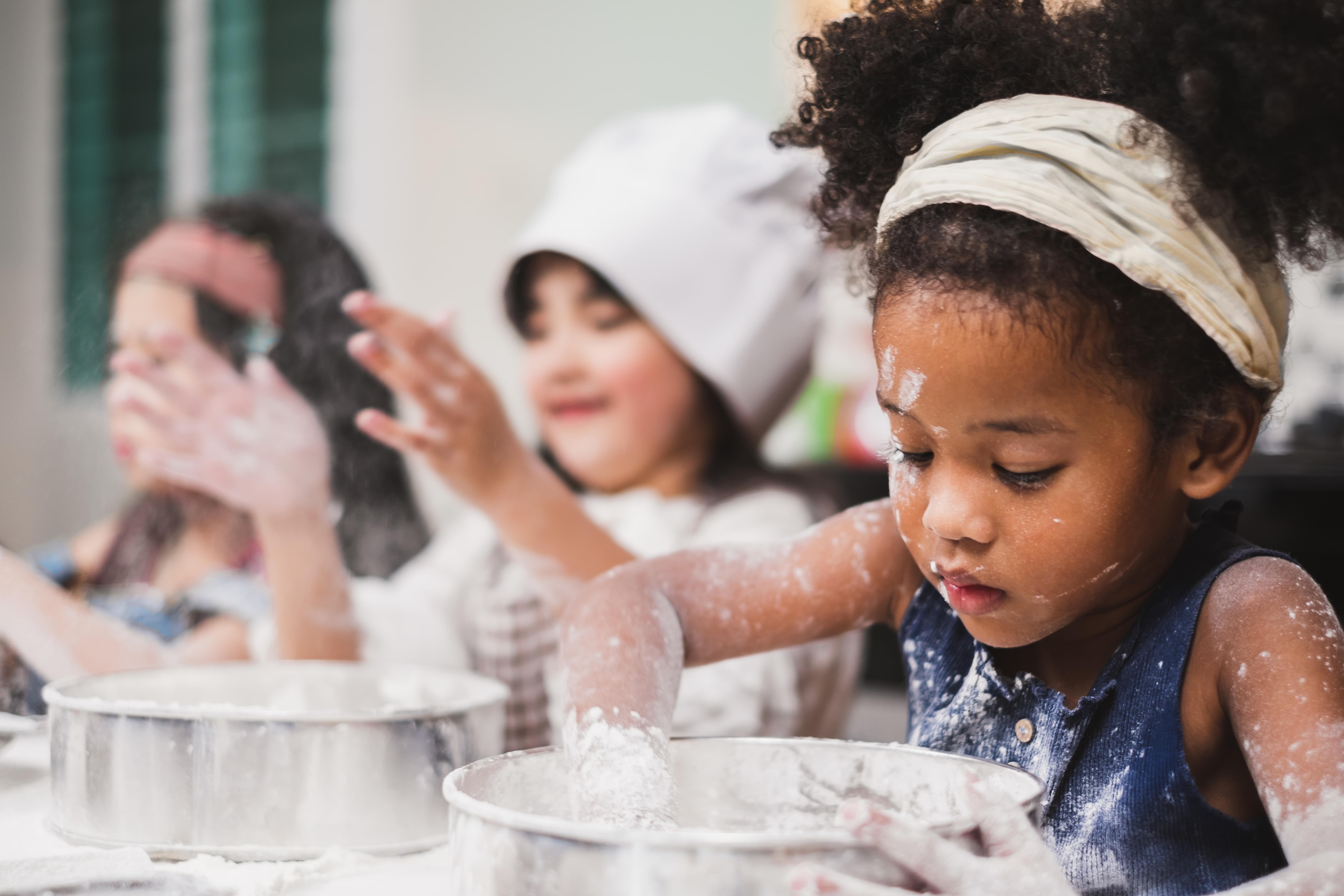 photo of a child making a cake